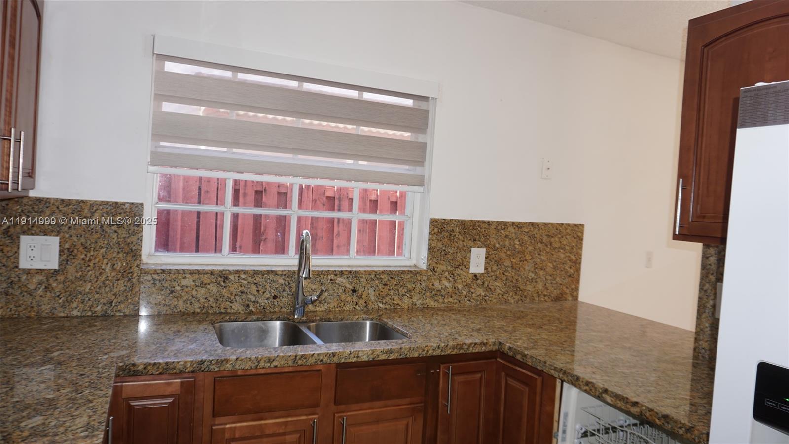 13479 Southwest 62nd Street Miami, FL 33183 - Photo 10 of 27 a kitchen with granite countertop a sink and a stove