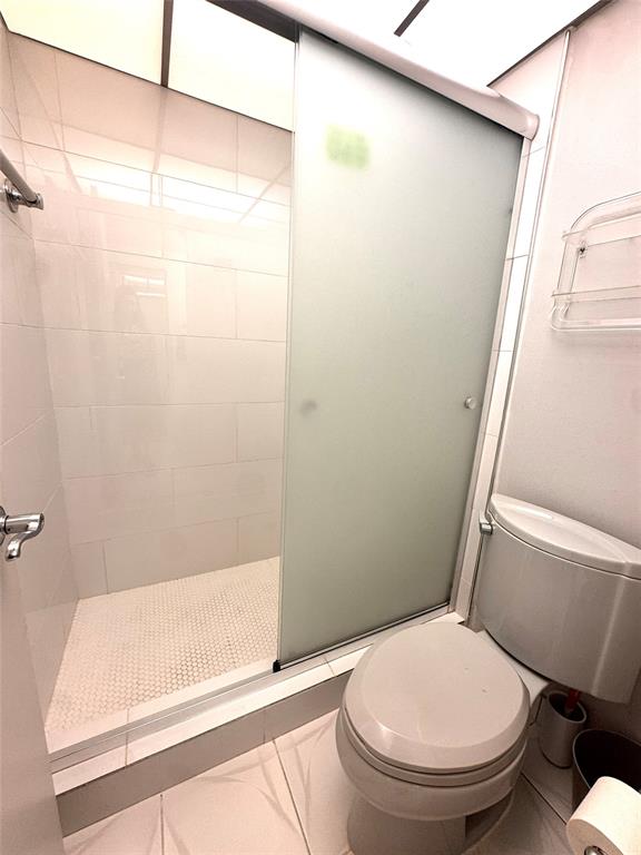 7950 West McNab Road, Unit 203 Tamarac, FL 33321 - Photo 11 of 21 a white toilet sitting next to a bath tub