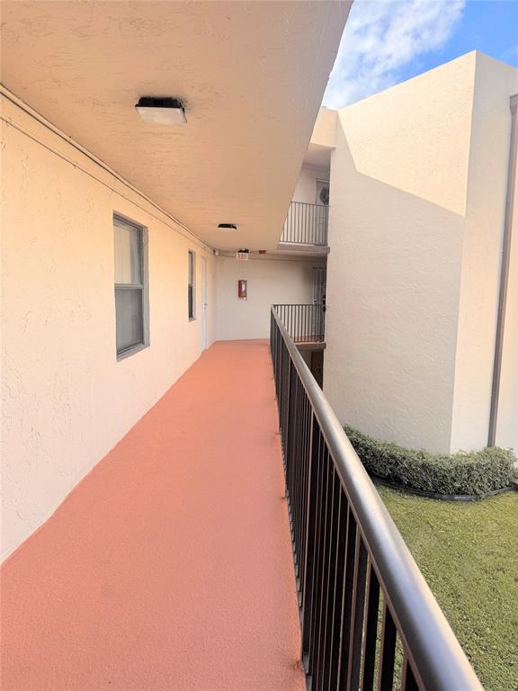 7950 West McNab Road, Unit 203 Tamarac, FL 33321 - Photo 2 of 21 a view of balcony and kitchen