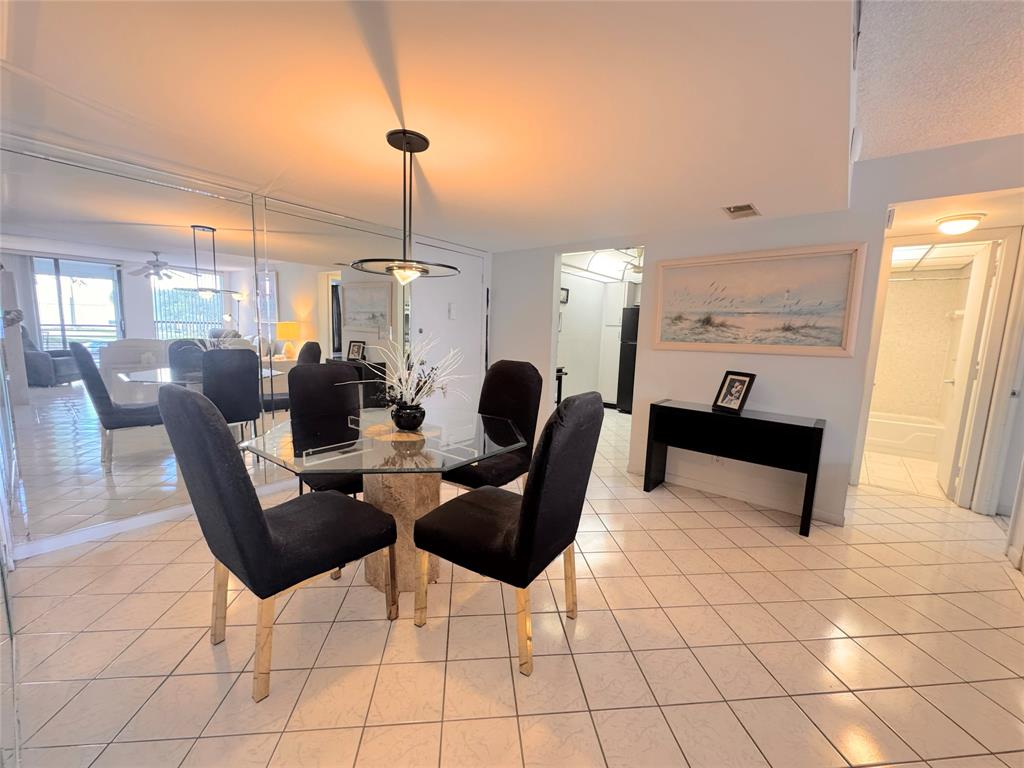 7950 West McNab Road, Unit 203 Tamarac, FL 33321 - Photo 4 of 21 a dining room with furniture and window