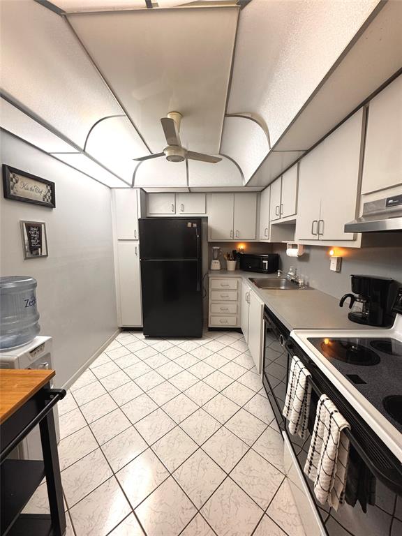 7950 West McNab Road, Unit 203 Tamarac, FL 33321 - Photo 5 of 21 a kitchen with stainless steel appliances kitchen island granite countertop a refrigerator a sink and a stove