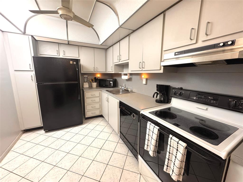 7950 West McNab Road, Unit 203 Tamarac, FL 33321 - Photo 6 of 21 a kitchen with stainless steel appliances granite countertop a refrigerator a stove a sink and dishwasher