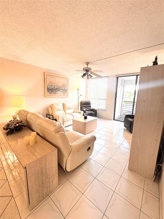 7950 West McNab Road, Unit 203 Tamarac, FL 33321 - Photo 8 of 21 a living room with furniture and a flat screen tv