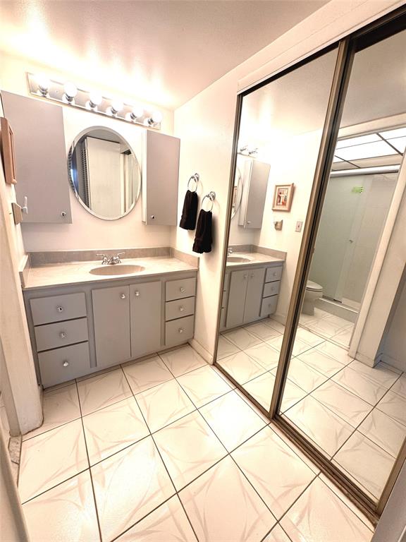 7950 West McNab Road, Unit 203 Tamarac, FL 33321 - Photo 10 of 21 a bathroom with a granite countertop sink a mirror and vanity