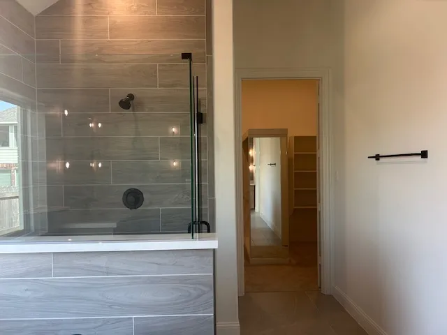 a bathroom with a shower and a sink