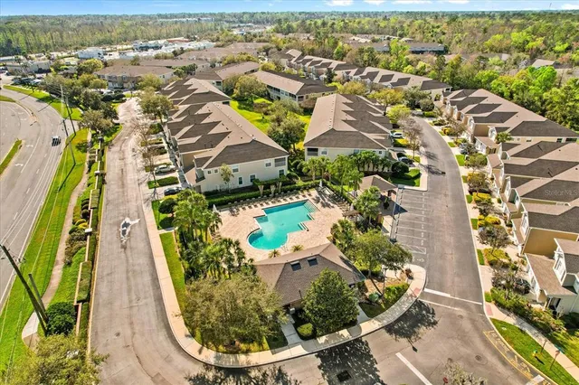 an aerial view of residential houses with outdoor space