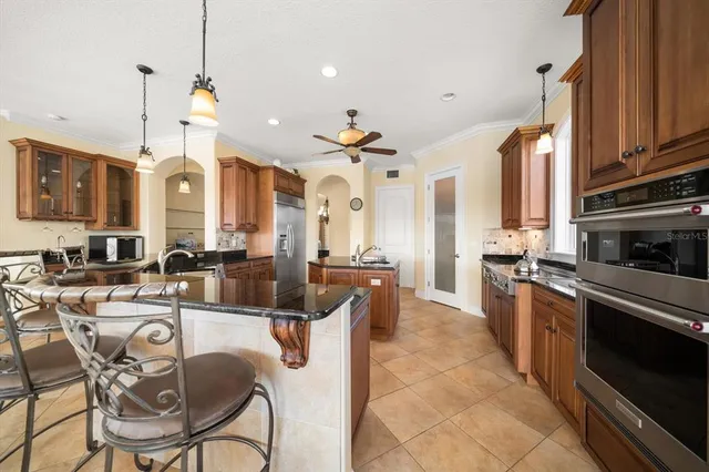 a living room with furniture fireplace and large windows
