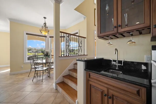 a bathroom with a granite countertop double vanity sink a mirror and a bathtub