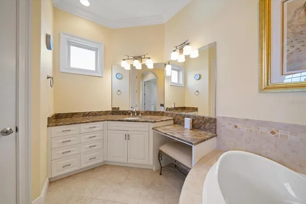 a bathroom with a granite countertop sink mirror vanity and toilet