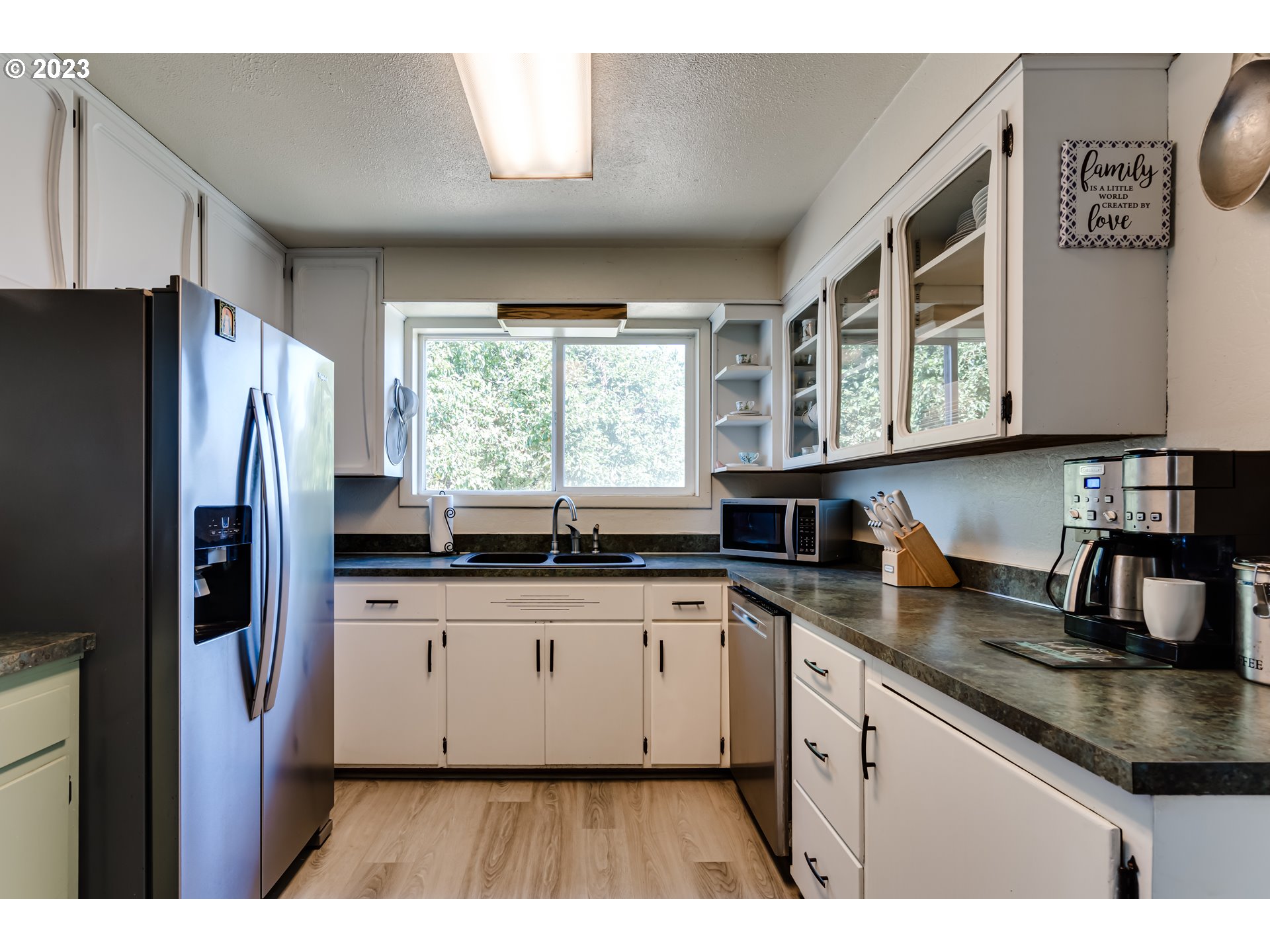 1400 I Street Springfield, OR 97477 - Photo 3 of 16 a kitchen with stainless steel appliances granite countertop a sink stove and refrigerator