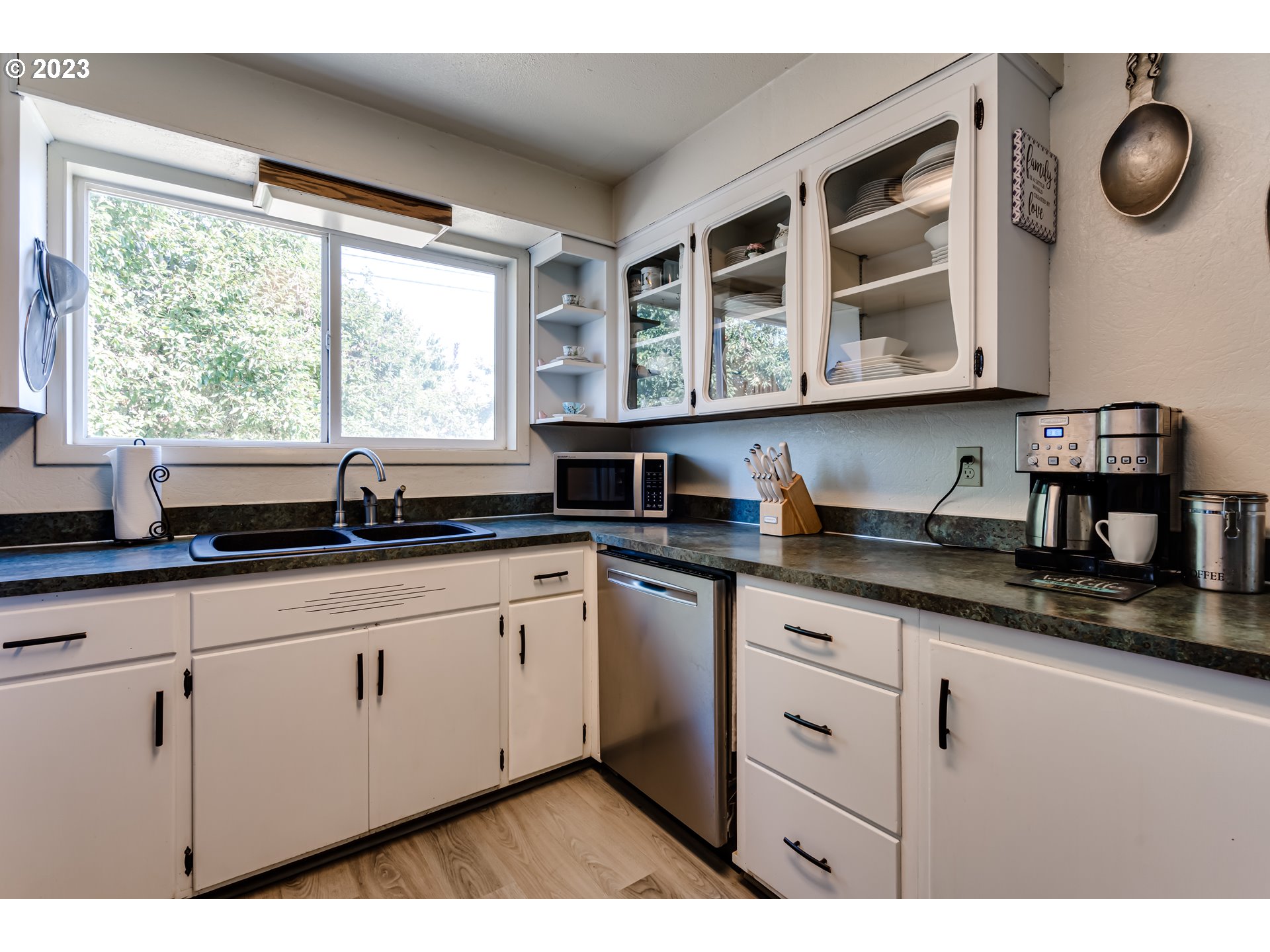 1400 I Street Springfield, OR 97477 - Photo 4 of 16 a kitchen with granite countertop a sink and a white wooden cabinets