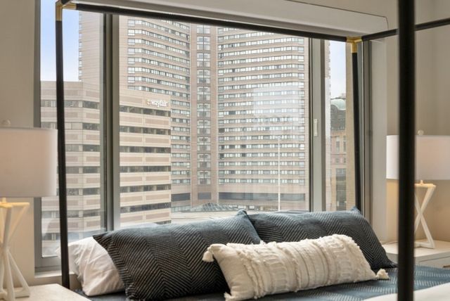 a bathroom with a granite countertop sink a toilet a mirror and shower