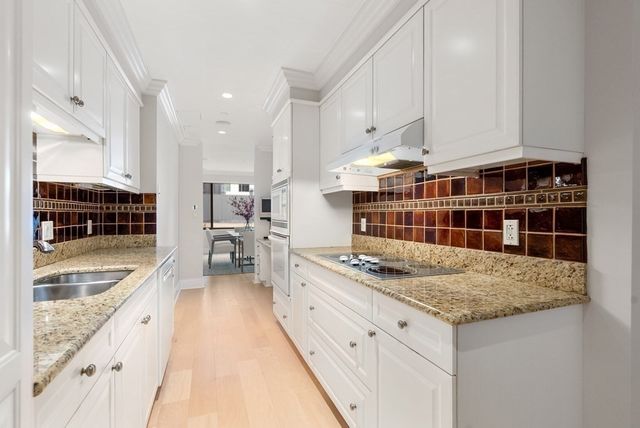a living room with furniture and large windows