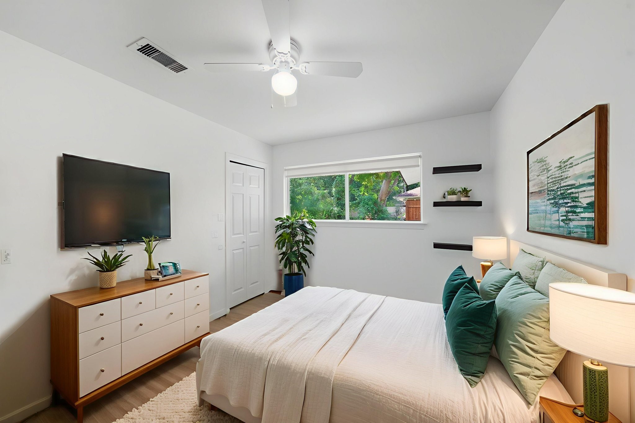 11223 Greenwillow Street Houston, TX 77035 - Photo 18 of 29 a bedroom with a large bed and a flat screen tv