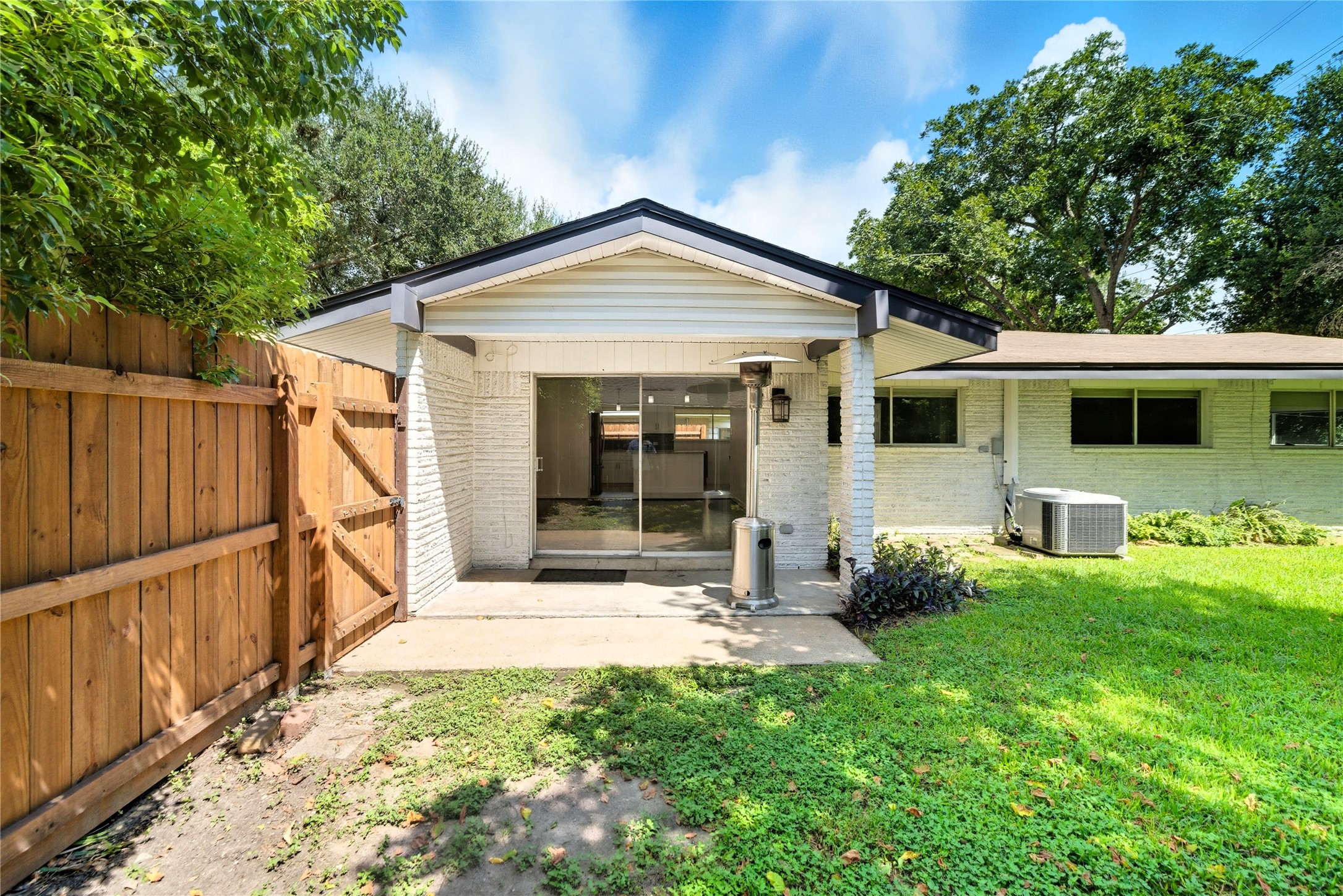11223 Greenwillow Street Houston, TX 77035 - Photo 26 of 29 a view of a house with wooden walls and a yard with a large tree