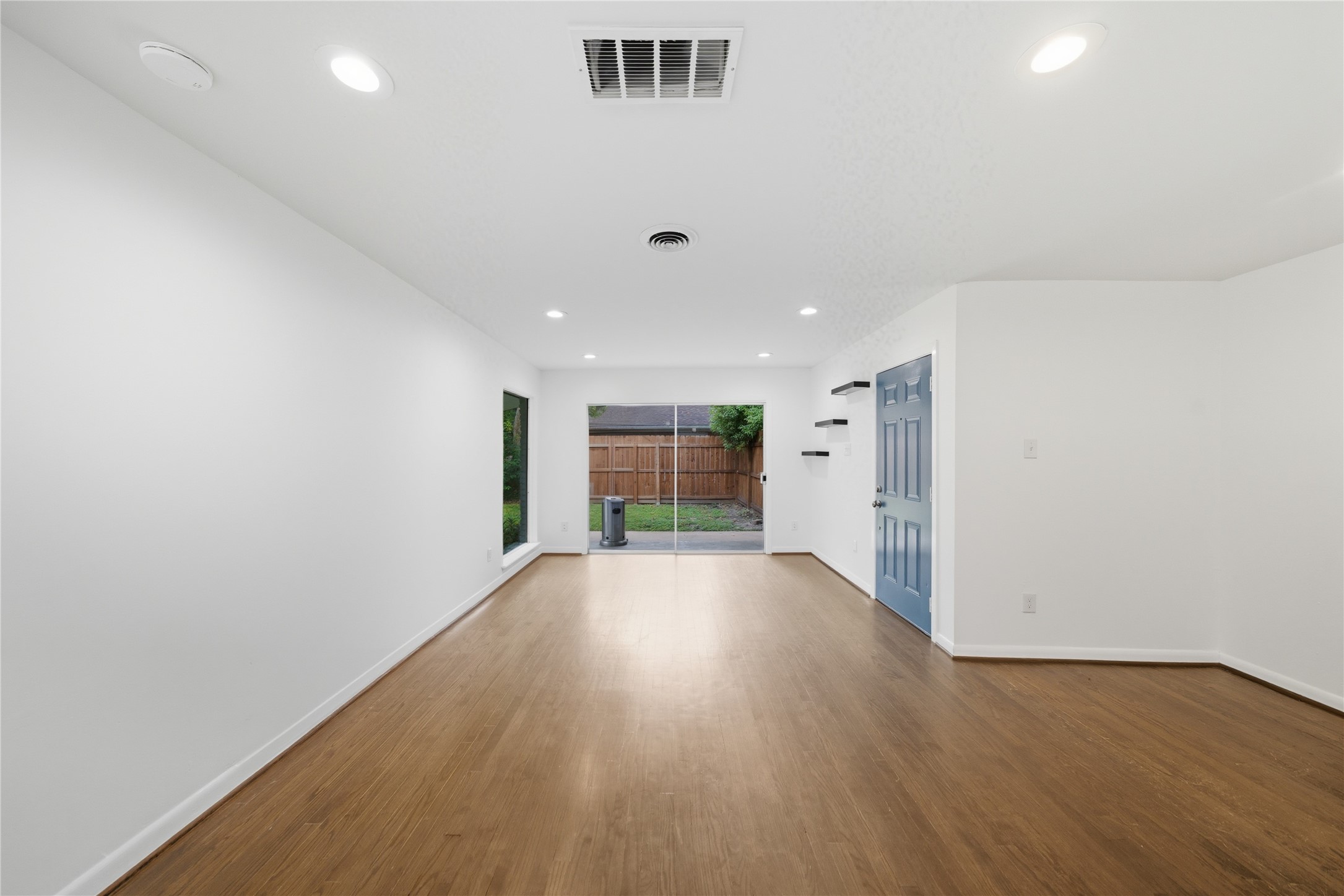 11223 Greenwillow Street Houston, TX 77035 - Photo 6 of 29 wooden floor in an empty room with a window