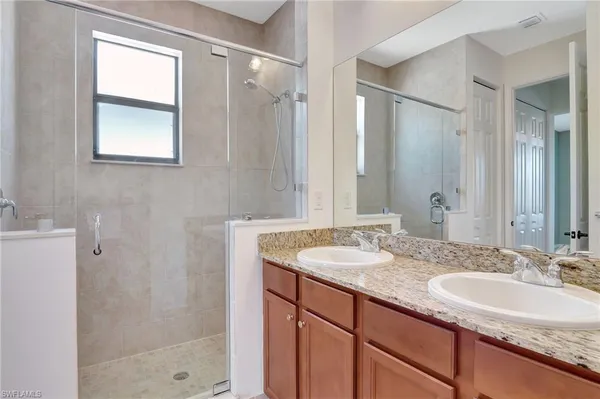 a bathroom with a granite countertop sink mirror and double