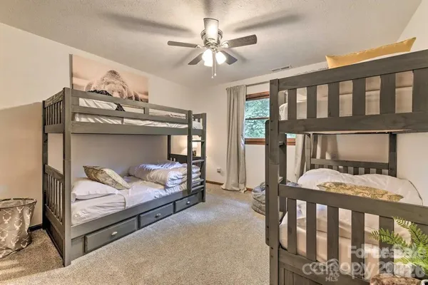 a bedroom with furniture and a chandelier