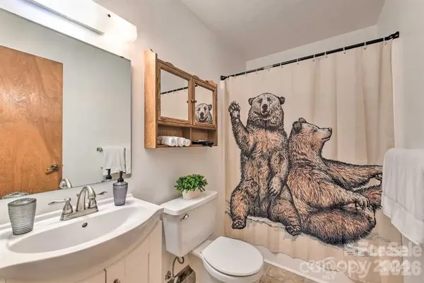a bathroom with a sink mirror vanity and toilet