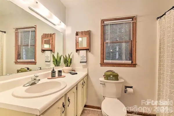 a bathroom with a sink double vanity and a toilet