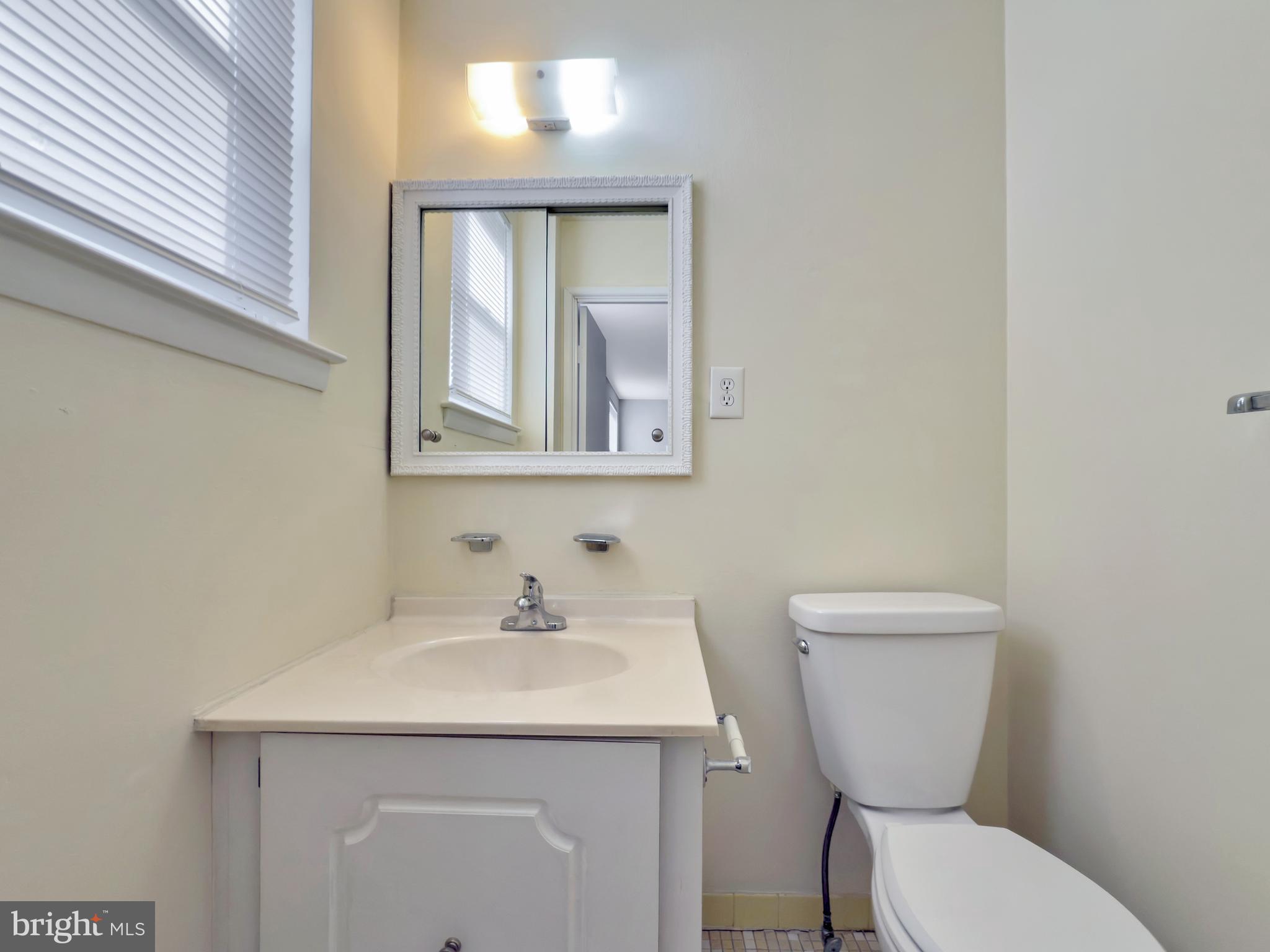 9754 East Roosevelt Boulevard, Unit 2 Philadelphia, PA 19115 - Photo 13 of 22 a bathroom with a toilet sink and mirror