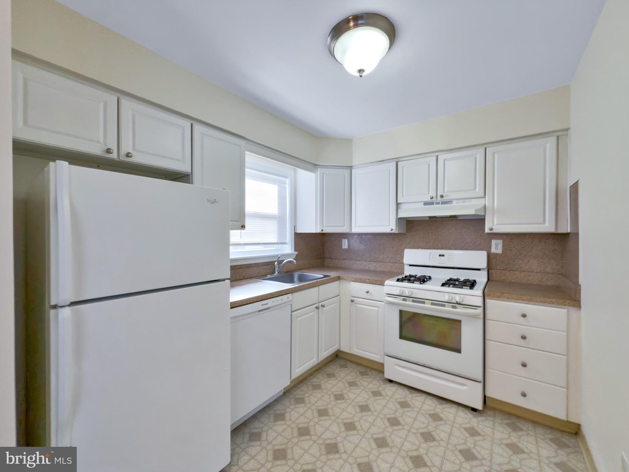 9754 East Roosevelt Boulevard, Unit 2 Philadelphia, PA 19115 - Photo 8 of 22 a kitchen with a white cabinets and white appliances