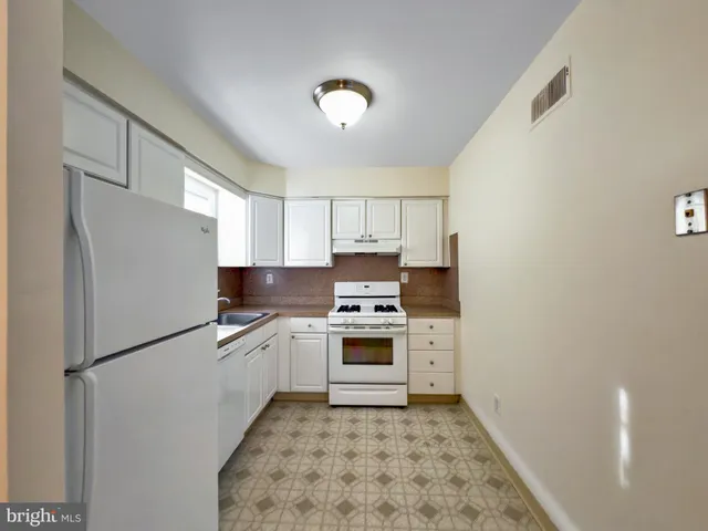 a white refrigerator freezer sitting in a kitchen