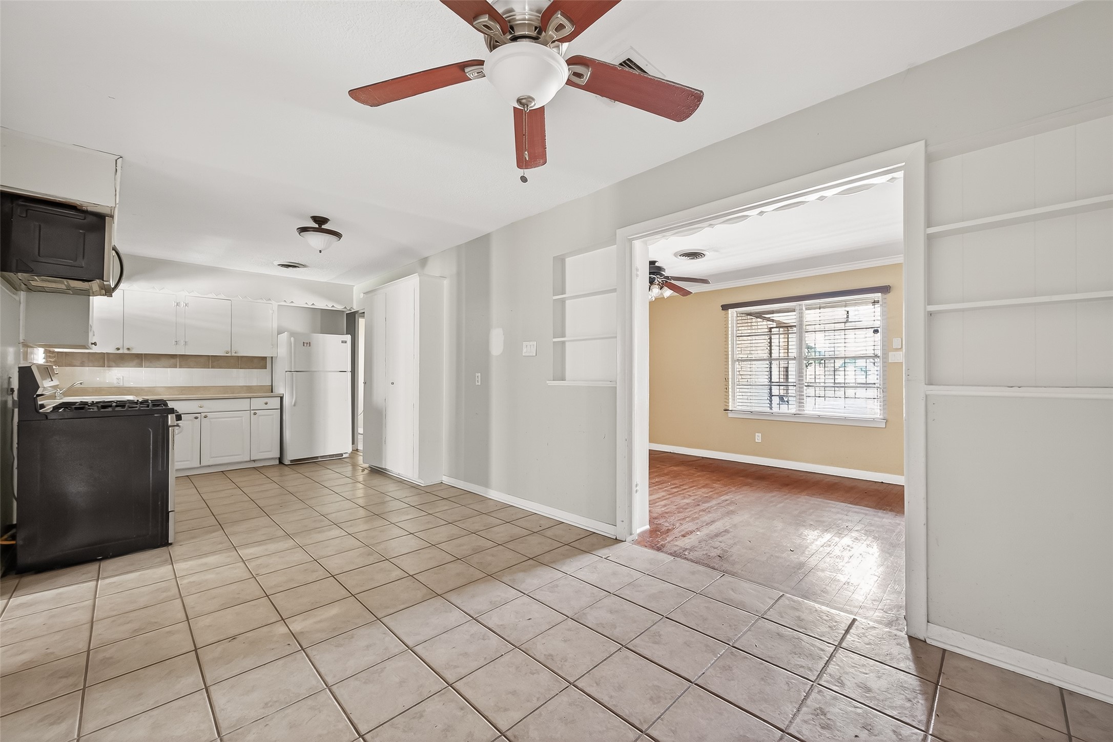 5114 West 43rd Street Houston, TX 77092 - Photo 13 of 31 a view of a kitchen with a sink and a stove top oven