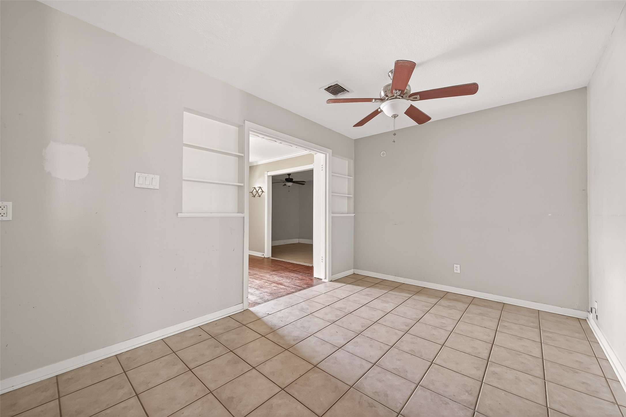 5114 West 43rd Street Houston, TX 77092 - Photo 16 of 31 a view of an empty room and chandelier fan
