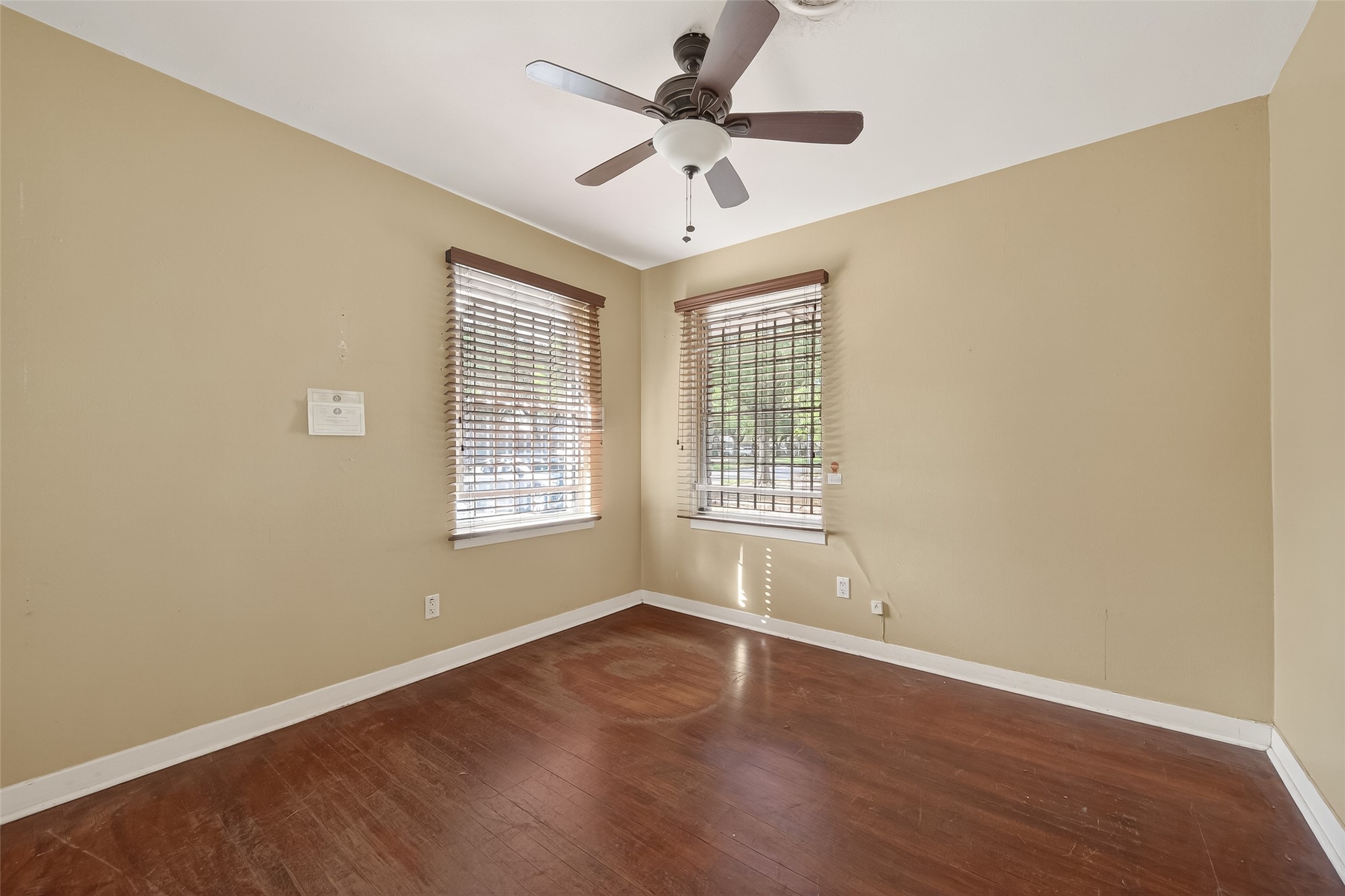 5114 West 43rd Street Houston, TX 77092 - Photo 26 of 31 a view of an empty room with a window and wooden floor