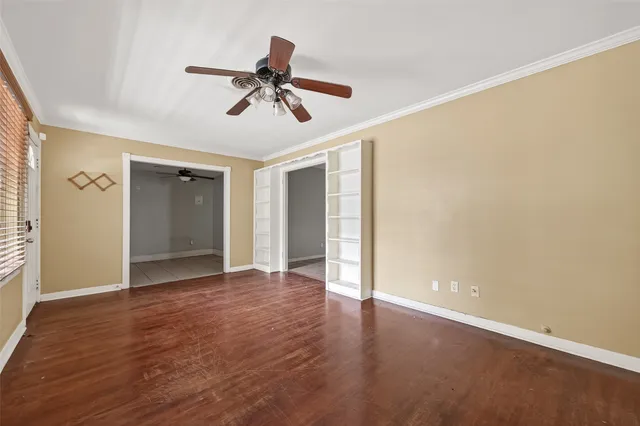 a view of an empty room and wooden floor