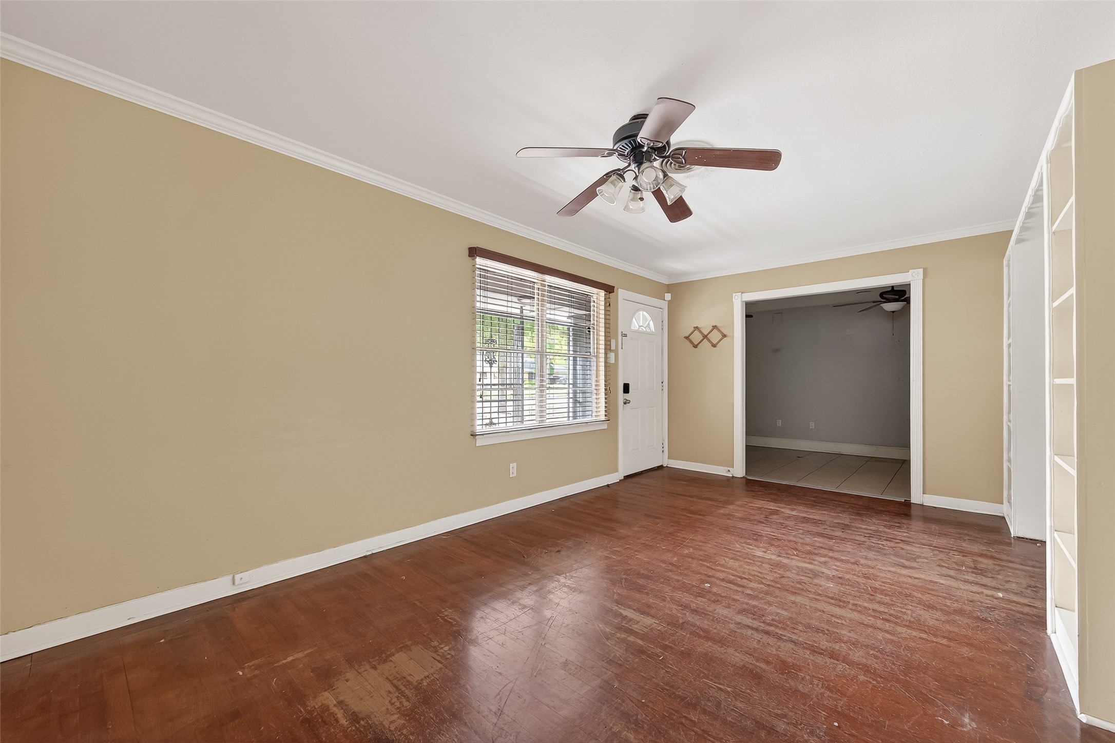5114 West 43rd Street Houston, TX 77092 - Photo 6 of 31 a view of empty room with wooden floor and fan