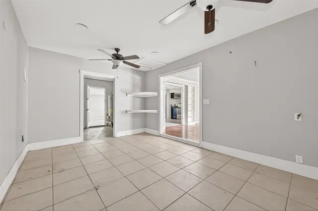 a view of an empty room with a ceiling fan