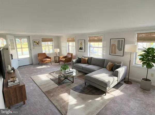 a living room with furniture potted plant and windows