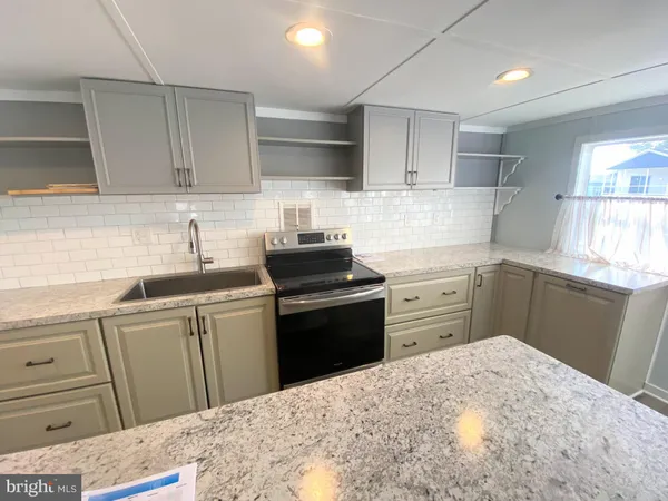 a kitchen with a sink stove and refrigerator