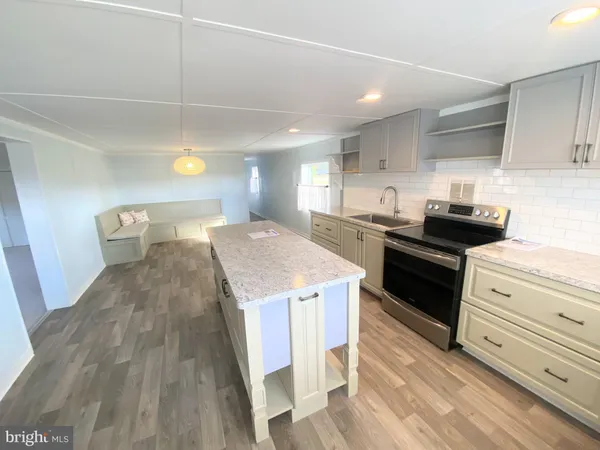a kitchen with a sink a stove and cabinets