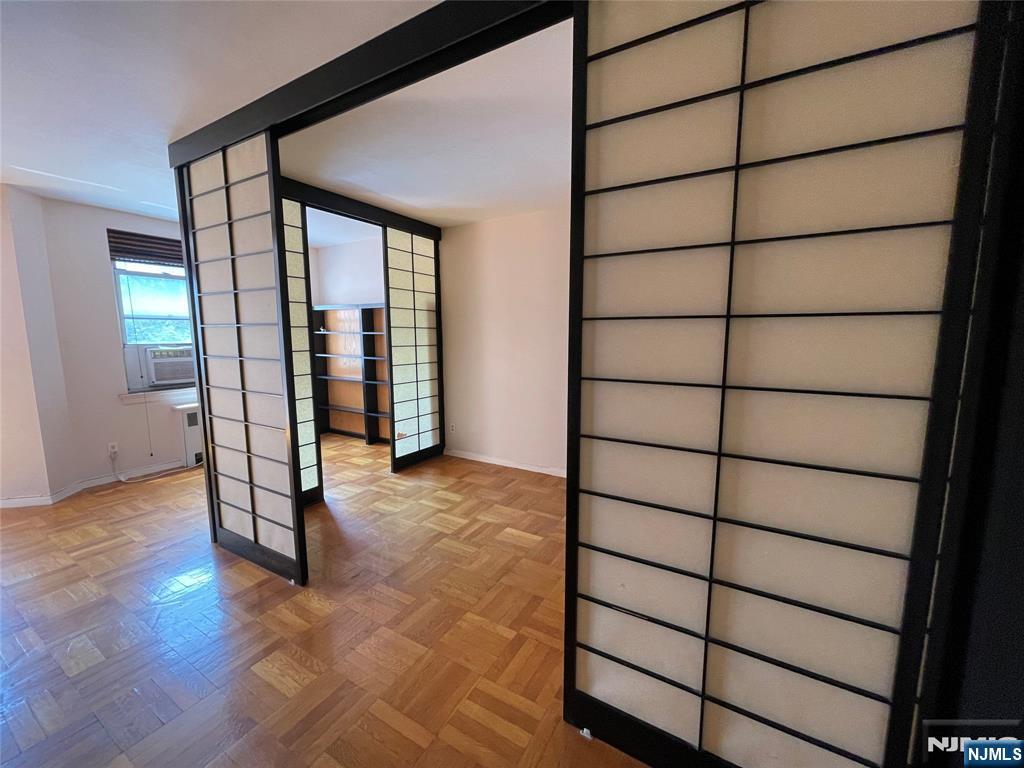 1450 Palisade Avenue, Unit 1F Fort Lee, NJ 07024 - Photo 4 of 8 a view of empty room with wooden floor and fan