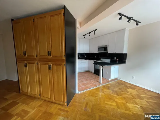 a view of a kitchen with wooden floor