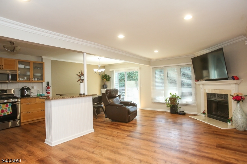 207 Patriots Road Morris Plains, NJ 07950 - Photo 5 of 25 a living room with furniture a fireplace and a flat screen tv