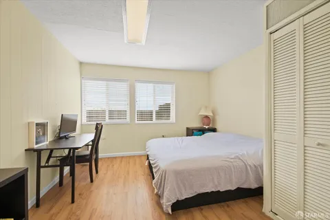 a bedroom with a bed and a table