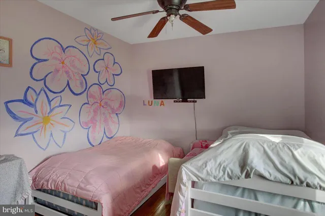 a bedroom with a bed and a television