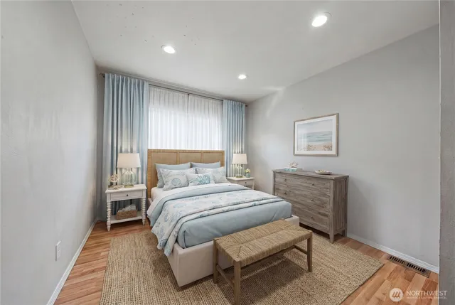 a bedroom with a bed and a night stand