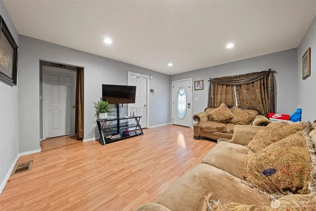 a spacious bedroom with a bed and a flat screen tv
