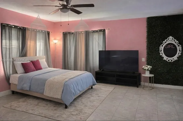 a bedroom with a bed and a flat screen tv