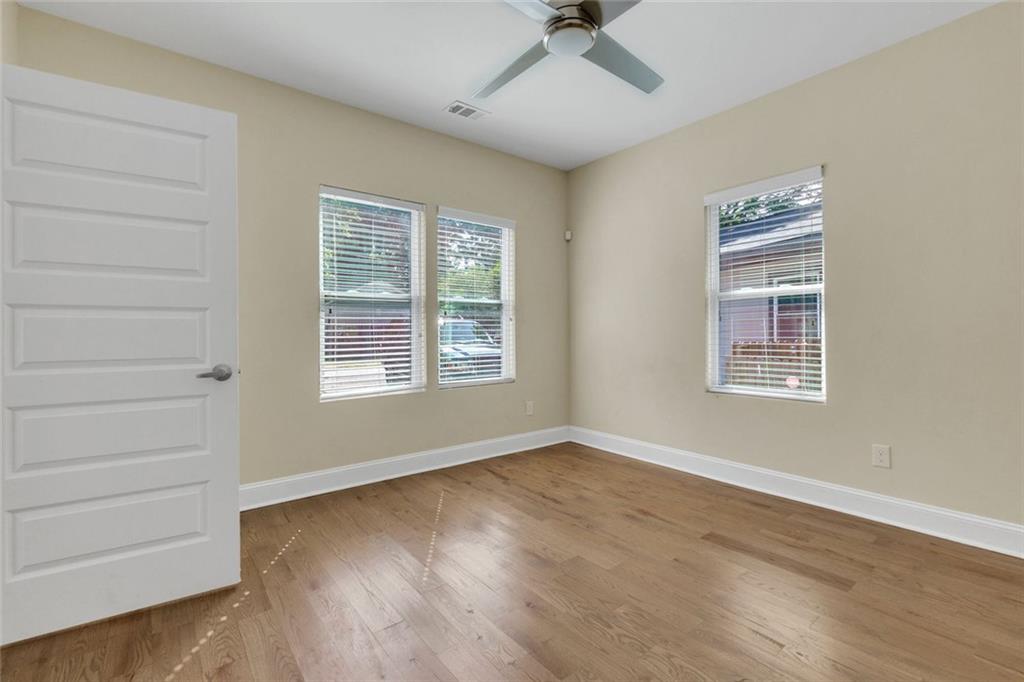 998 Mayson Turner Road Northwest, Unit A Atlanta, GA 30314 - Photo 17 of 26 a view of an empty room with a window and wooden floor