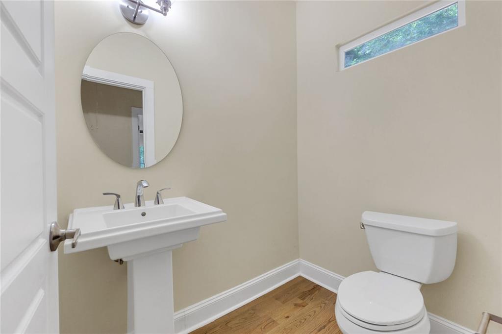 998 Mayson Turner Road Northwest, Unit A Atlanta, GA 30314 - Photo 22 of 26 a bathroom with a toilet sink and mirror