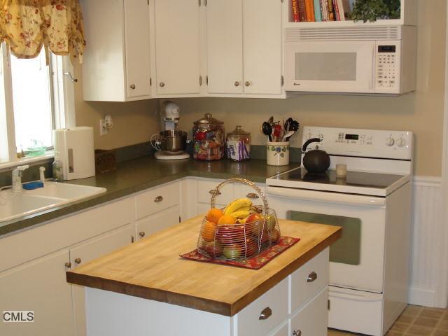 a kitchen with a sink a stove and cabinets