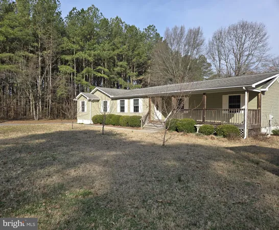 a view of backyard with deck and outdoor seating