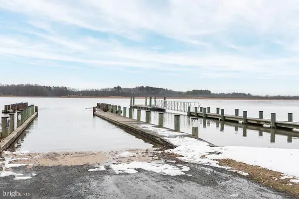 a street sign on a sidewalk next to a road