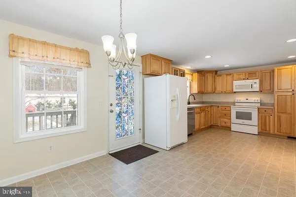a kitchen with stainless steel appliances granite countertop a sink and cabinets with wooden floor